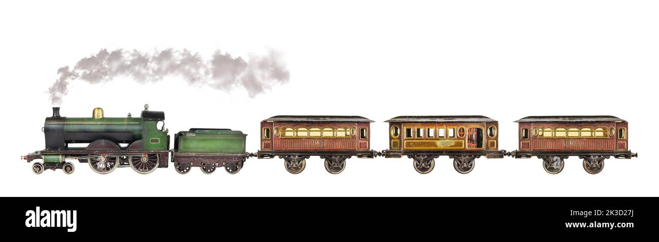 Vintage rusted and weathered toy passenger train with locomotive isolated on a white background Stock Photo