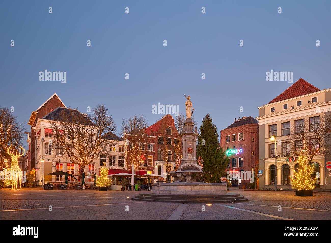 Deventer, The Netherlands - December 20, 2021: The central Brink square in the historic Dutch city Deventer in winter with christmas trees and decorat Stock Photo