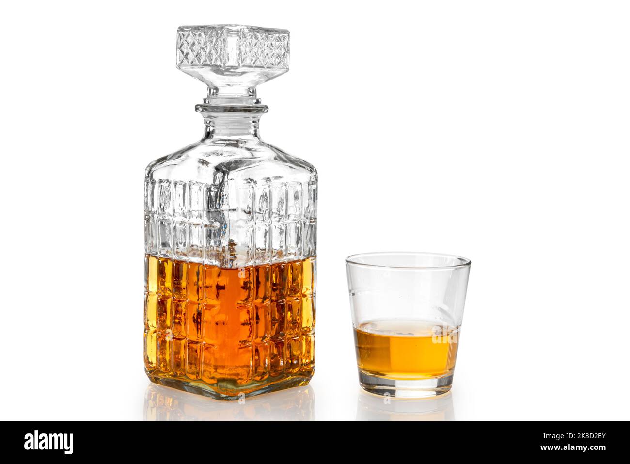 Whiskey in decorated crystal glass bottle, whisky or bourbon in vintage bottle with glass isolated on white, clipping path Stock Photo