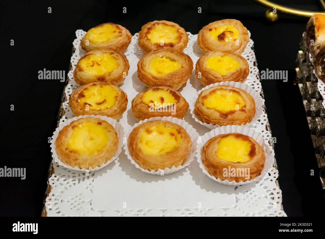 group of delicious egg tart on white tray with black background Stock Photo