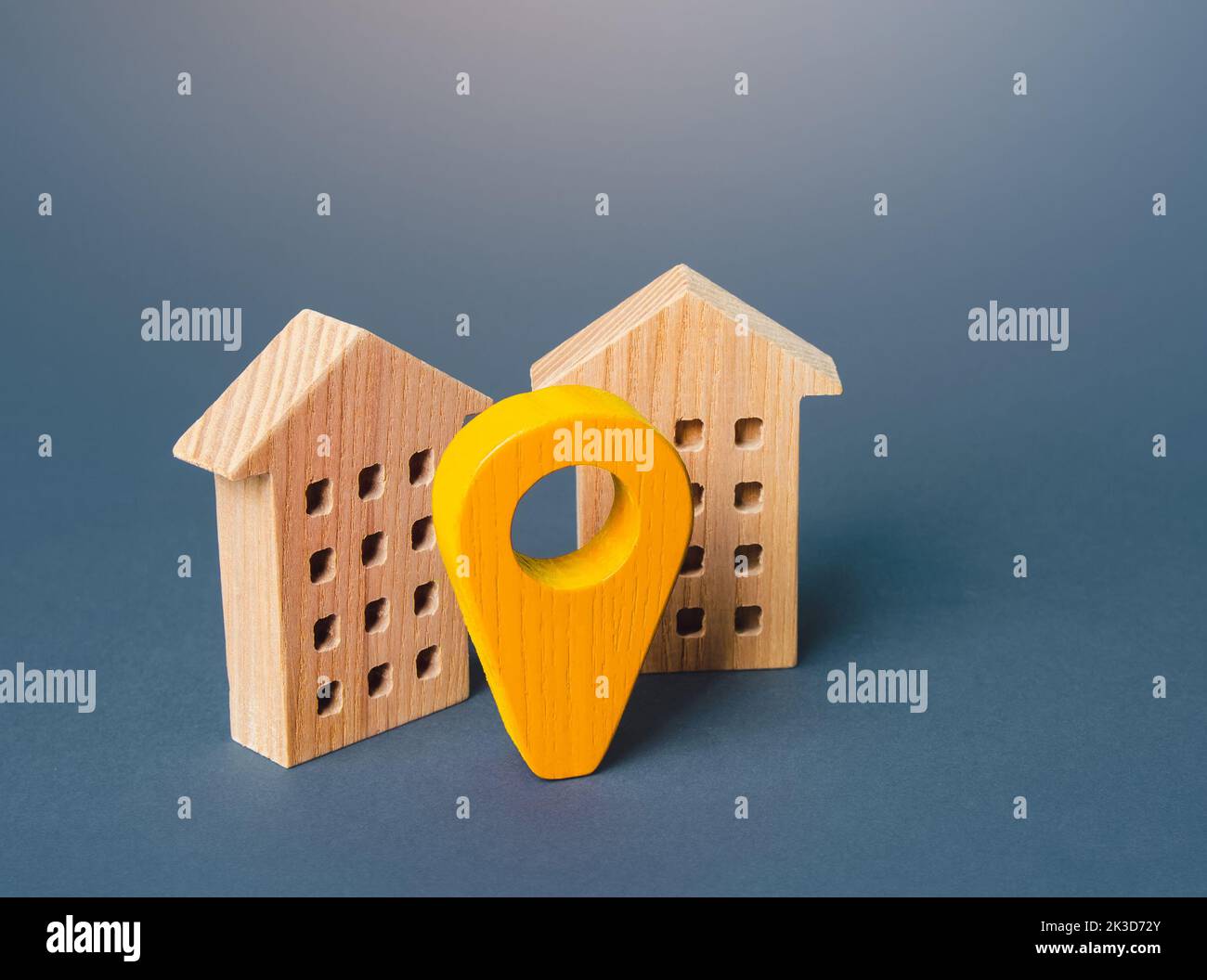 Yellow geo location pin and two houses. Tracking, city navigation