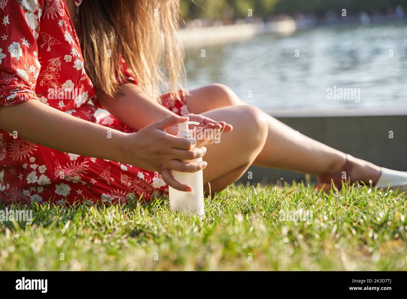 woman using sun tan lotion. young latina putting on skin care cream. Stock Photo