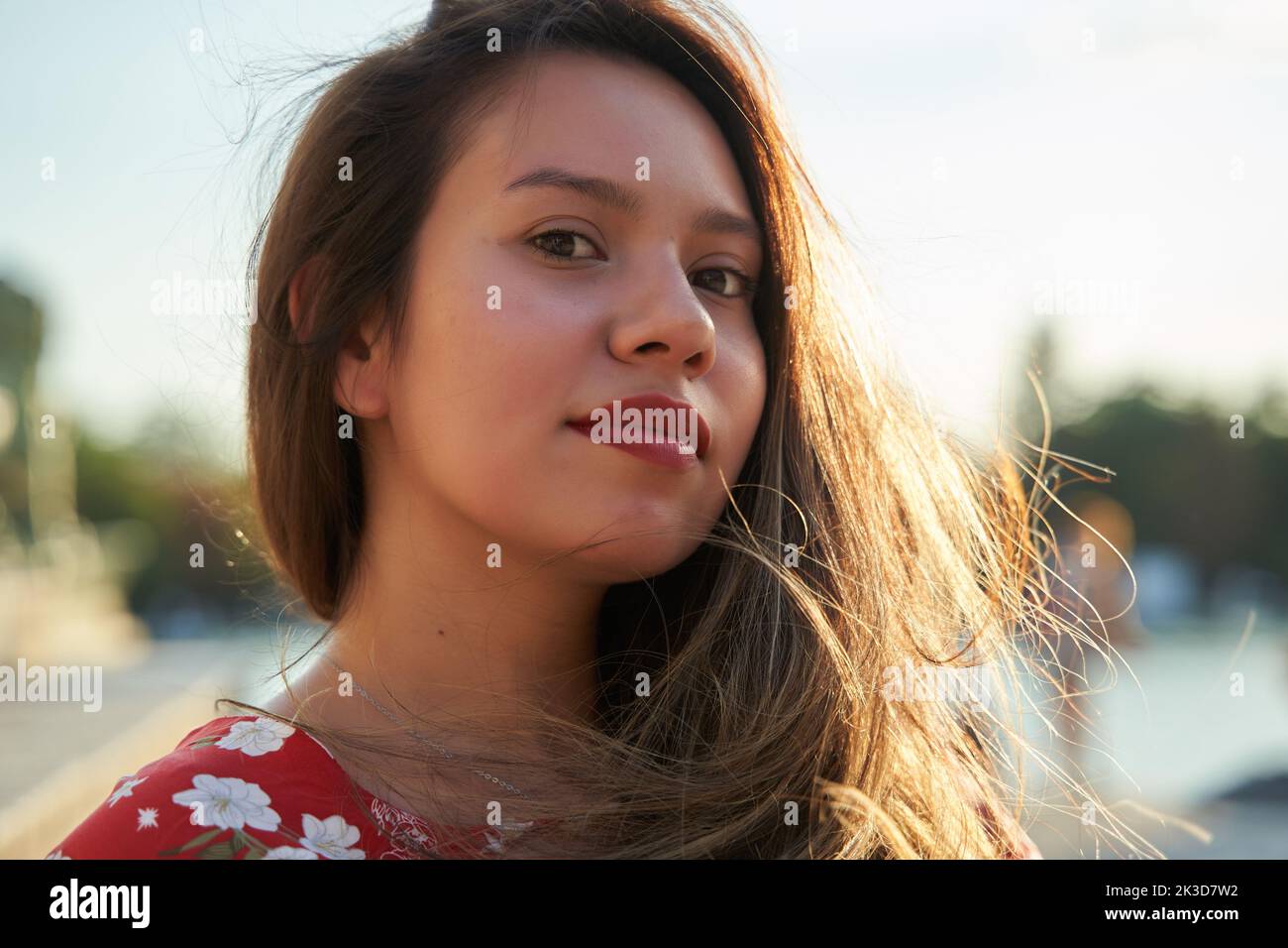 close-up portrait of a young latina with long hair and red lips Stock Photo