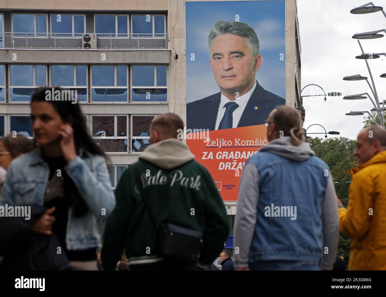 People pass by an election poster in Sarajevo, Bosnia, September 25, 2022. REUTERS/Dado Ruvic Stock Photo