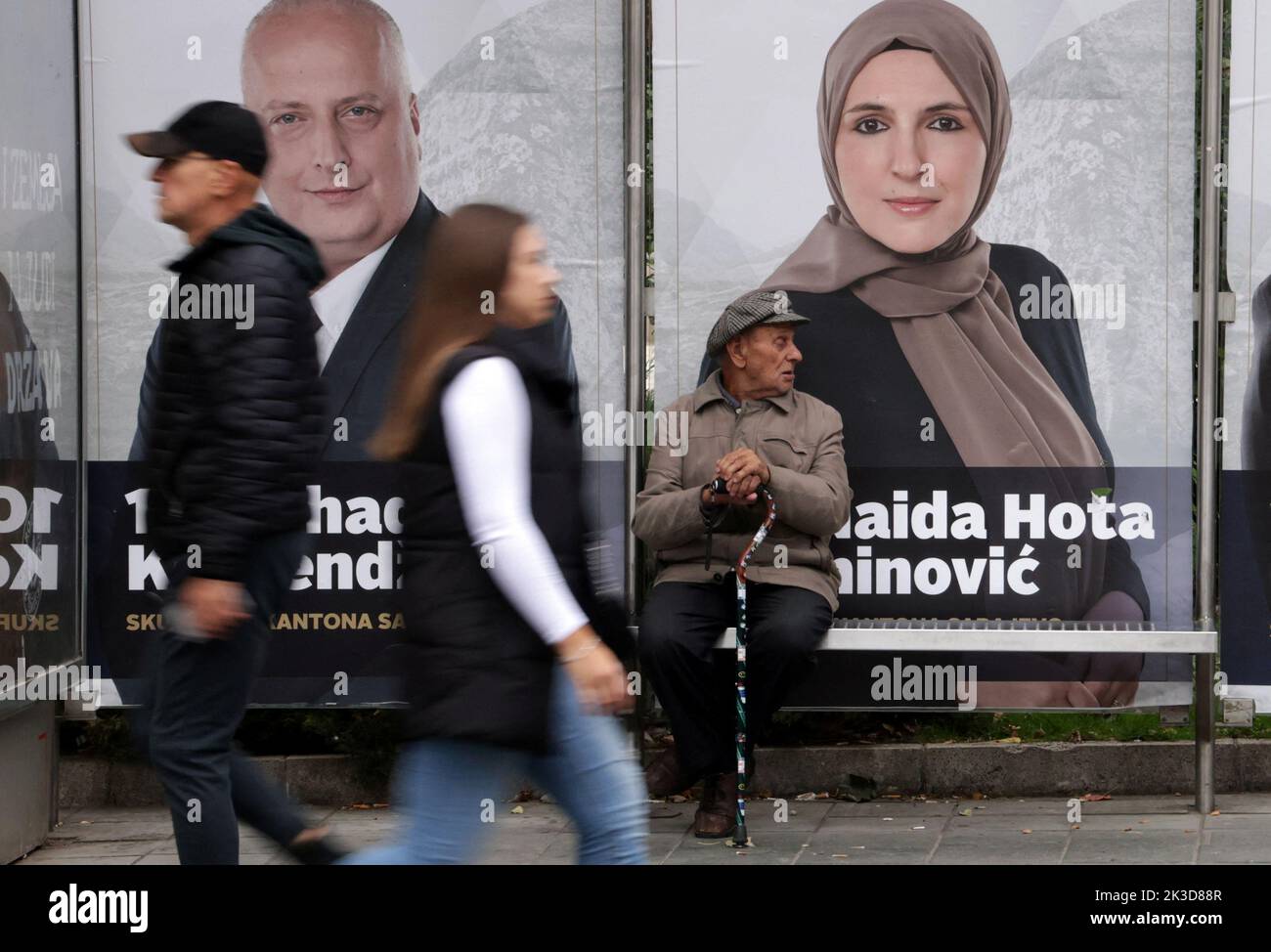 People pass by election posters in Sarajevo, Bosnia, September 25, 2022. REUTERS/Dado Ruvic Stock Photo