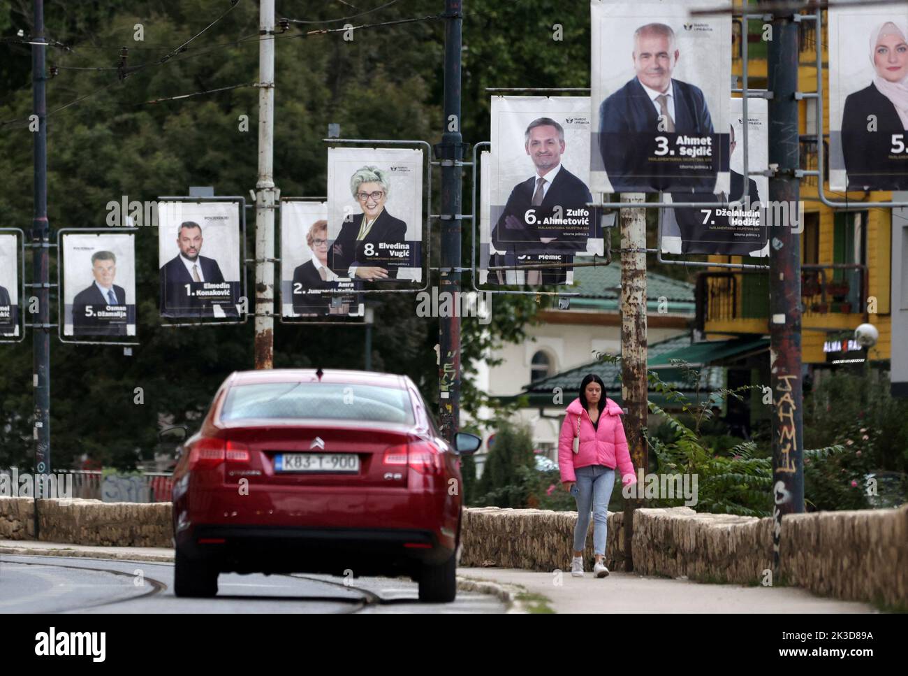A woman walks past election posters in Sarajevo, Bosnia, September 25, 2022. REUTERS/Dado Ruvic Stock Photo