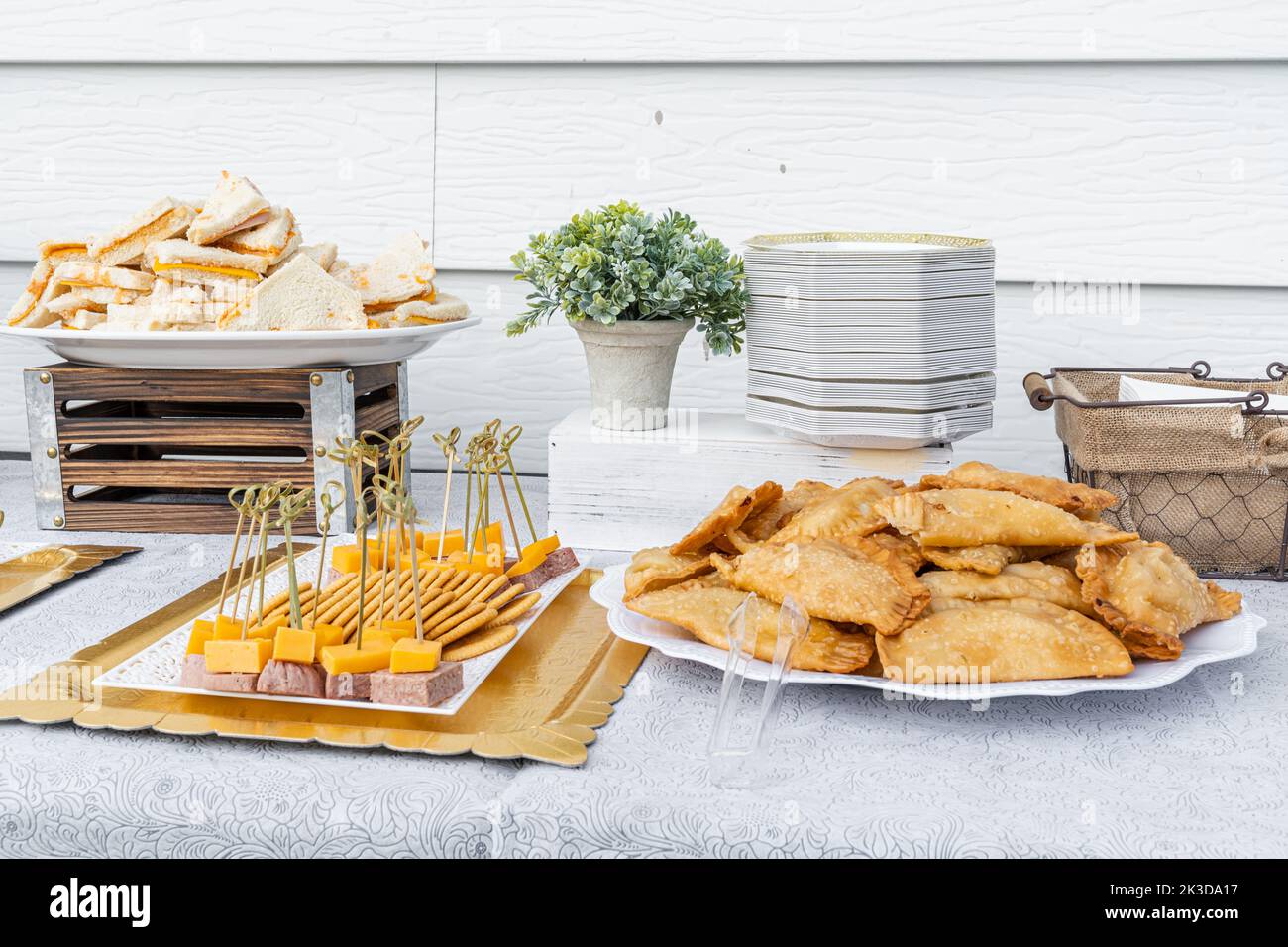 Traditional Dominican Appetizers of Empanadas, Cheese Sandwiches and Skewer Salami and Cheese with Crackers on a Table. Stock Photo