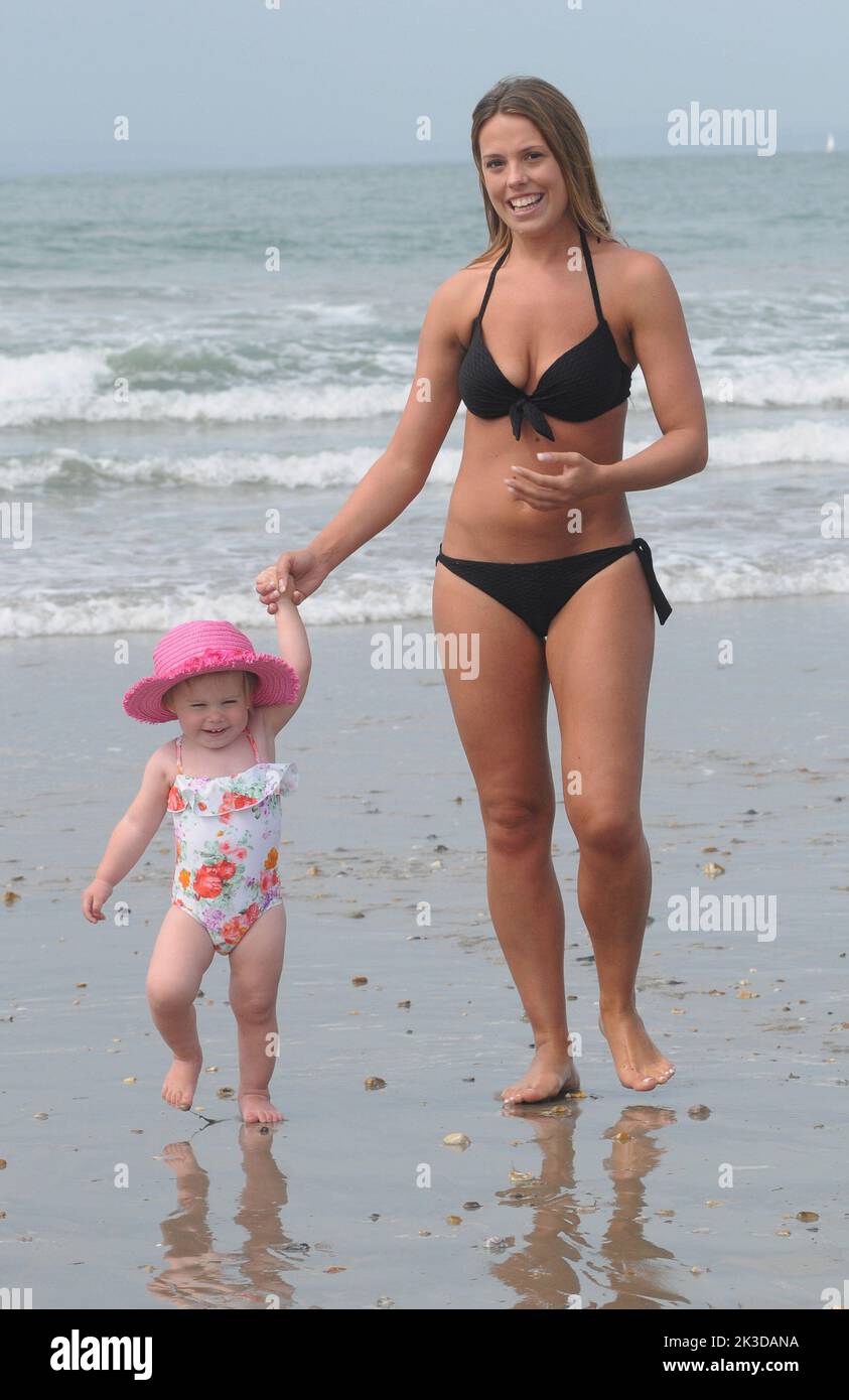 Charlotte  Guest and 1 year old Eviee Gray on the beach at West Wittering, West Sussex on the hottestb day of the year. Pic Mike Walker,2015 Mike Walker Pictures Stock Photo