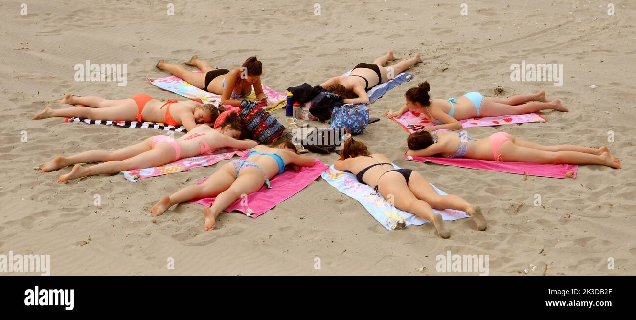 A group of girls sunbathe on the beach at West Wittering, West Sussex on the hottest day of the year. Pic Mike Walker,2015 Mike Walker Pictures Stock Photo