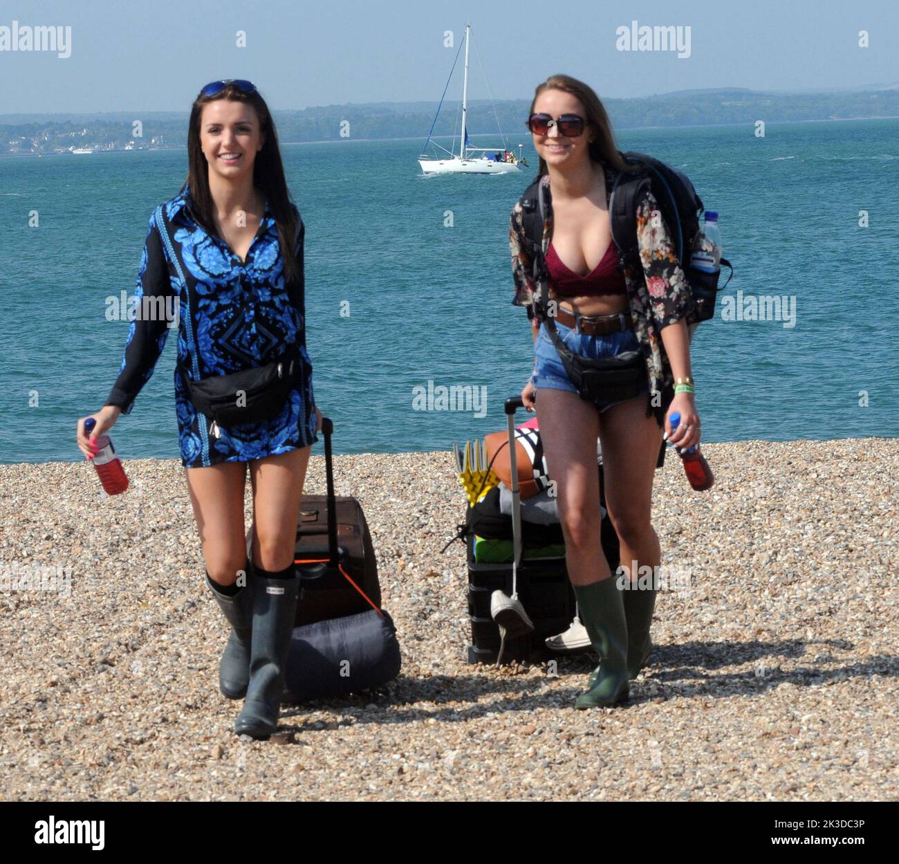 Music fans Daisy Crew, left, and Mollie Dyer head for the hovercraft at Southsea ready for a great weekend at the Isle of Wight music festival Pic Mike Walker,2015 Mike Walker Pictures Stock Photo