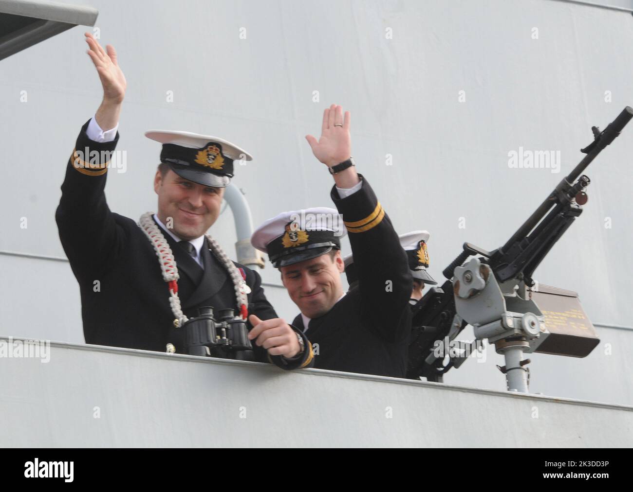 Officers wave from the bridge as HMS Severn arrives back in Portsmouth after an eight month deployment in the Caribbean. Pic Mike Walker,2015 Stock Photo