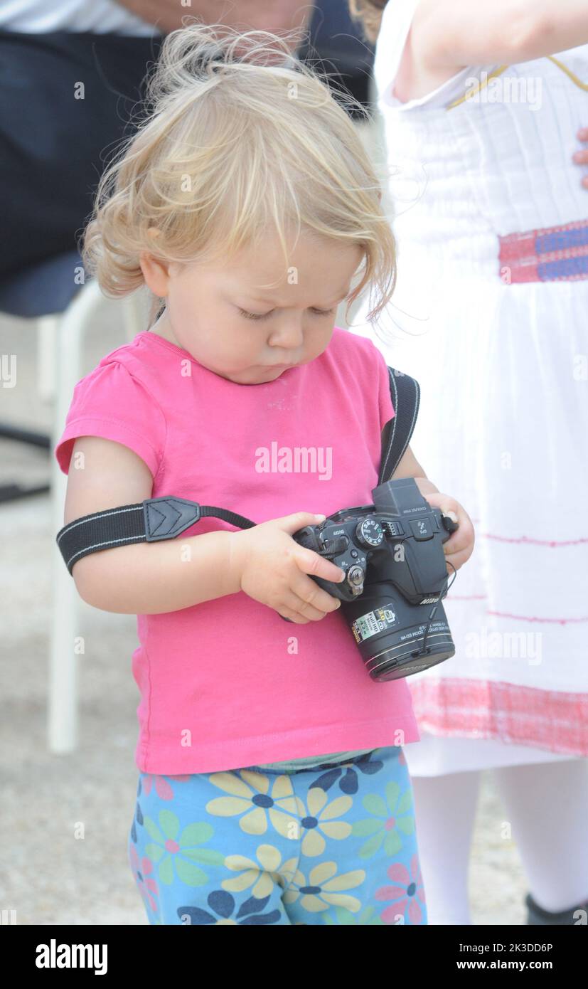 Commanding officer's daughter arabella Banfield, aged one, checks her pictures as HMS Severn arrives back in Portsmouth after an eight month deployment in the Caribbean. Pic Mike Walker,2015 Stock Photo