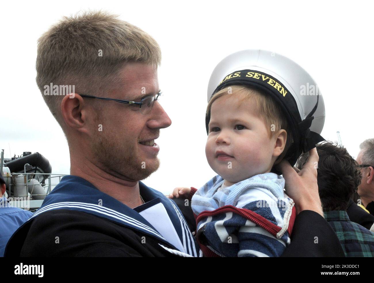 Able seaman Chris Mackins is reunited with his son Leo, aged one, as HMS Severn arrives back in Portsmouth after an eight month deployment in the Caribbean. Pic Mike Walker,2015 Stock Photo