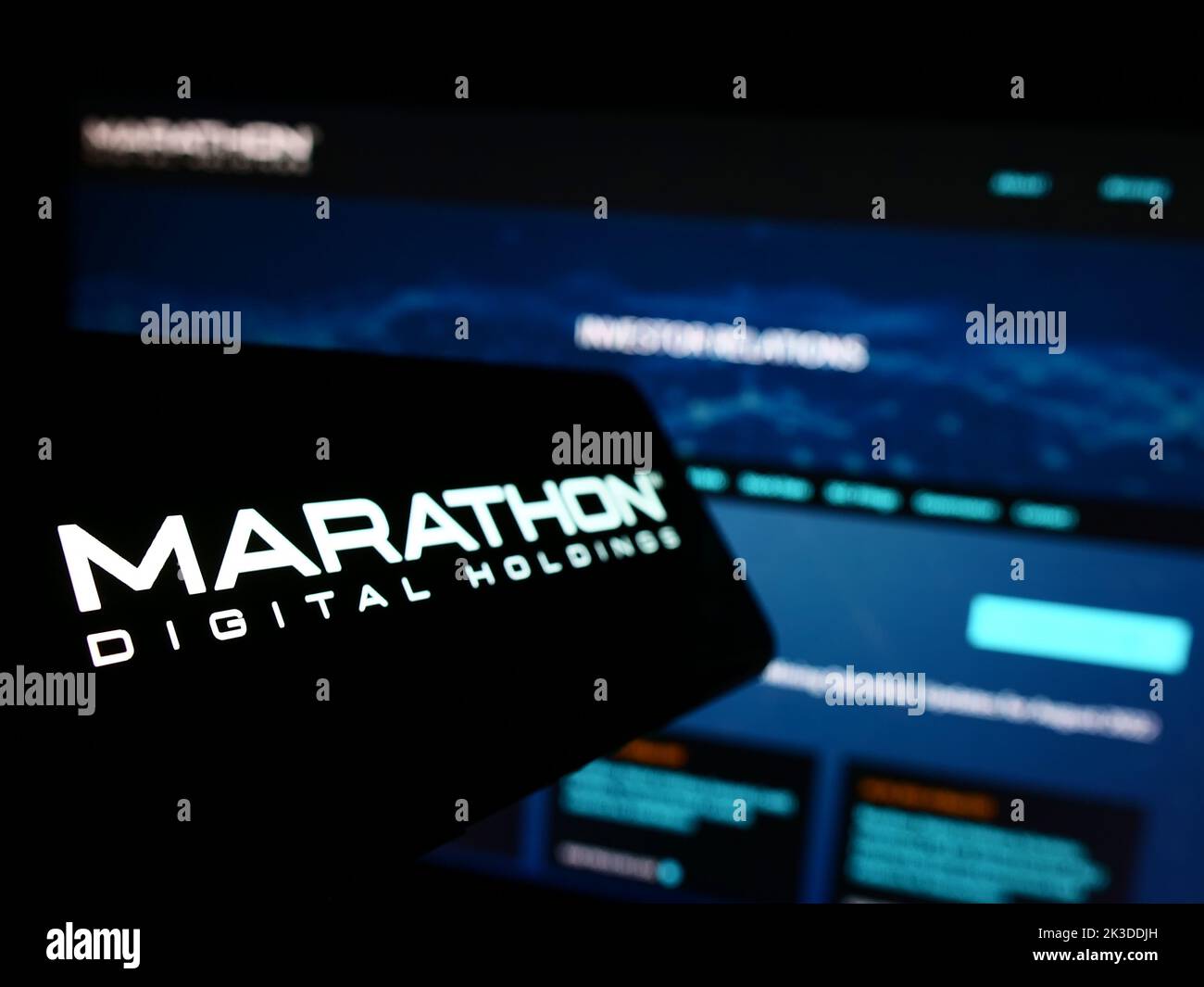 Mobile phone with logo of American company Marathon Digital Holdings Inc. on screen in front of business website. Focus on left of phone display. Stock Photo