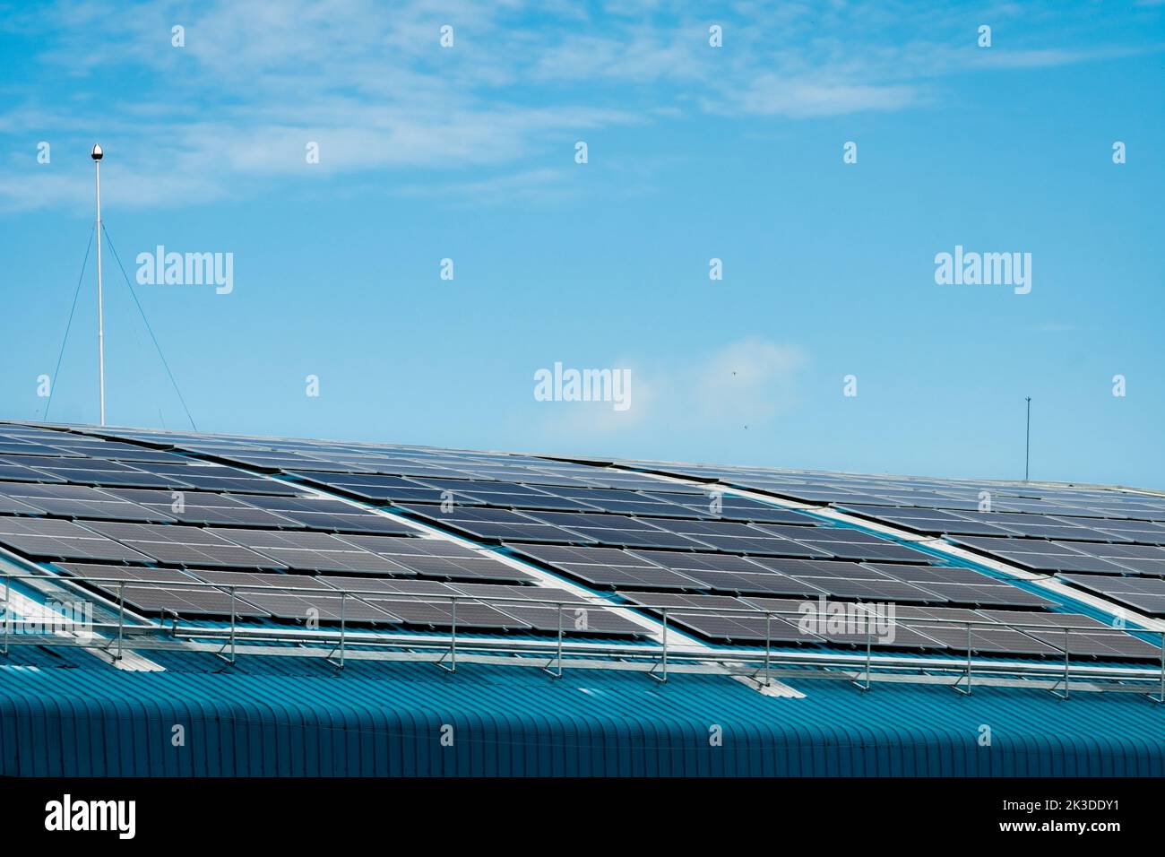 Solar energy for factory or warehouse building. Solar panels on the roof of industrial plant. Commercial solar. Industrial photovoltaic panels. Roof Stock Photo