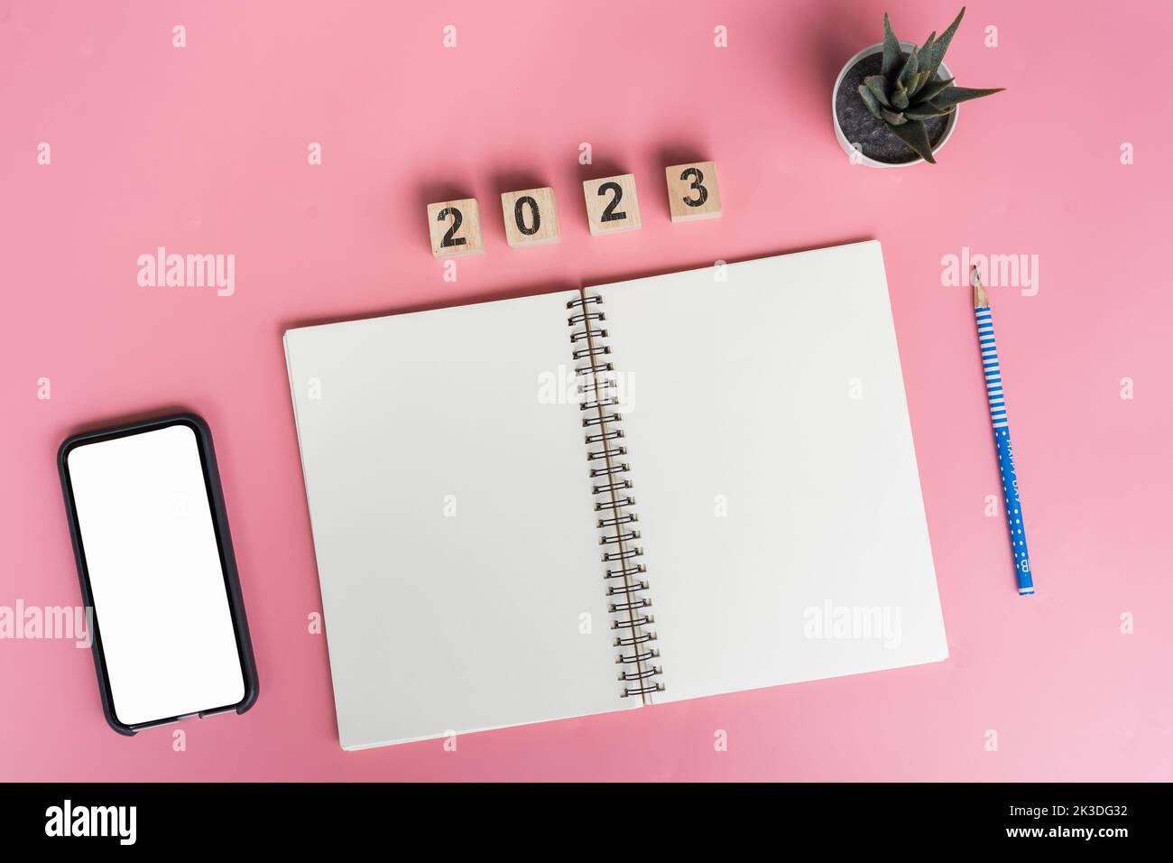 Notebooks with empty goals for 2023 year and phone on color background Stock Photo