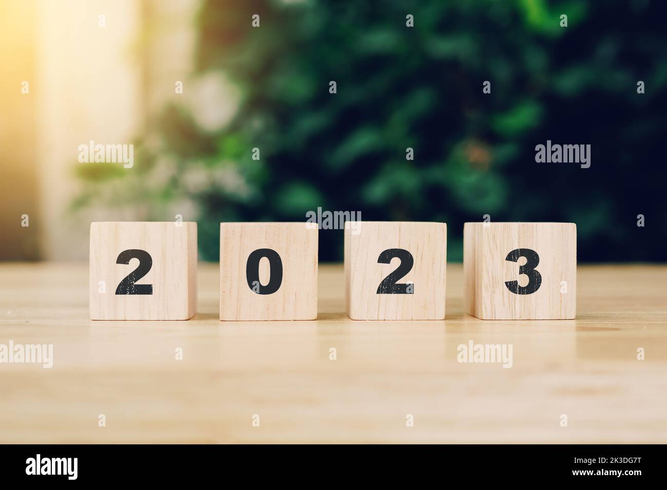 2023 happy new year on wood block on wood table with sunlight. new year concept. Stock Photo