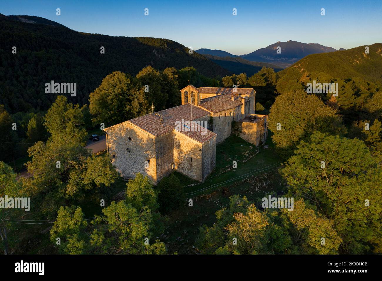 Aerial view of the Falgars sanctuary and the Catllaràs mountain range at sunrise with fog in the Lillet valley (Berguedà, Barcelona, Catalonia, Spain) Stock Photo