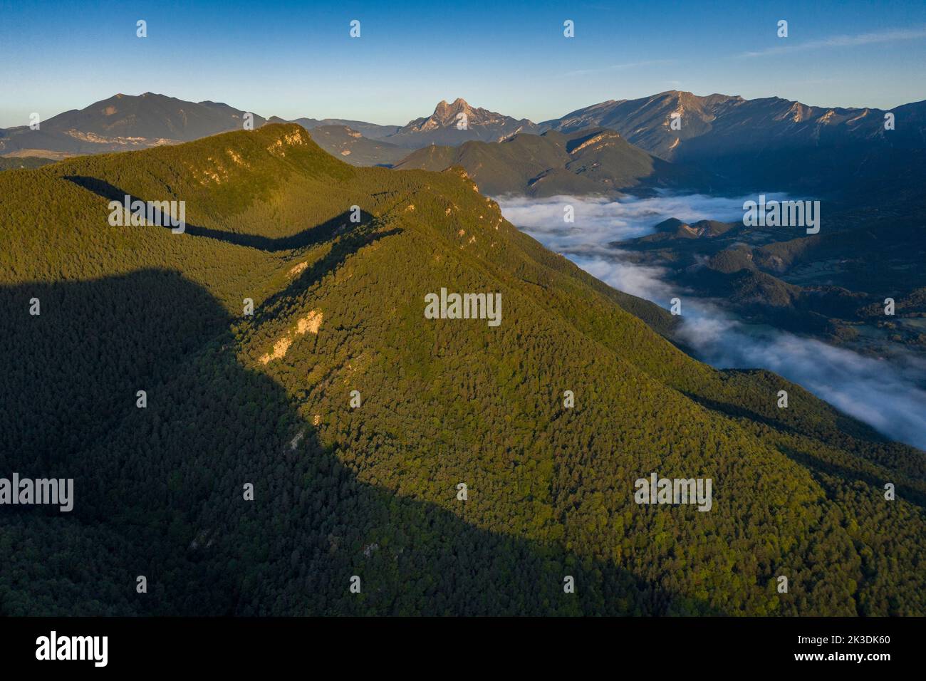 Aerial view of the Falgars sanctuary and the Catllaràs mountain range at sunrise with fog in the Lillet valley (Berguedà, Barcelona, Catalonia, Spain) Stock Photo