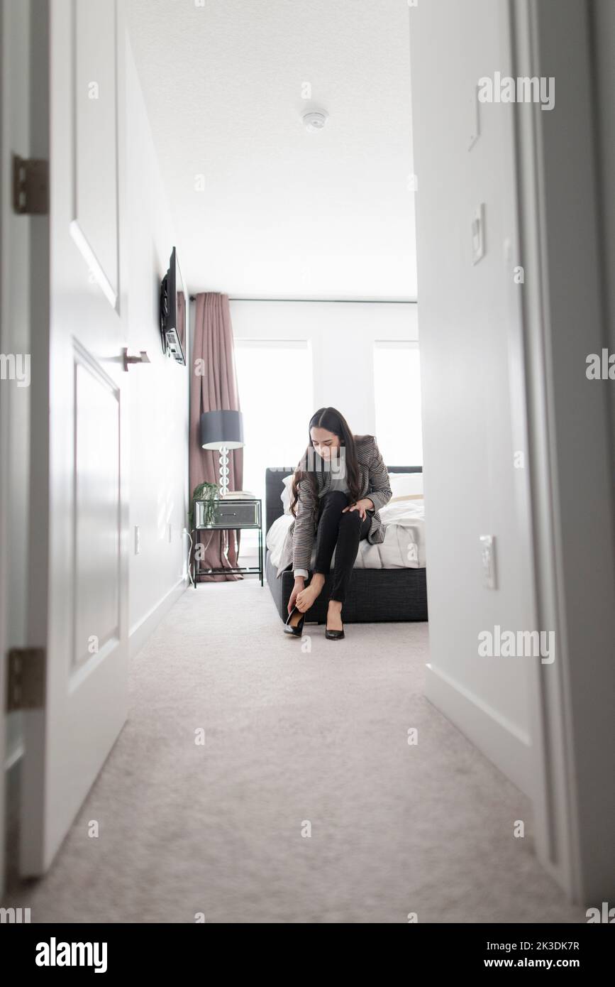 Putting on high heels in bedroom hi-res stock photography and images ...