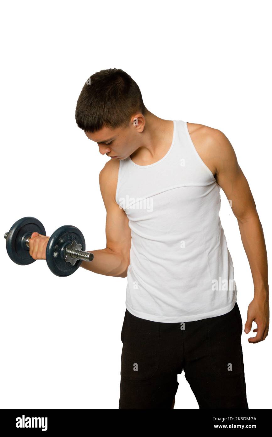 19 year olf teenageboy wearing a tanktop lifting a dumbbell Stock Photo