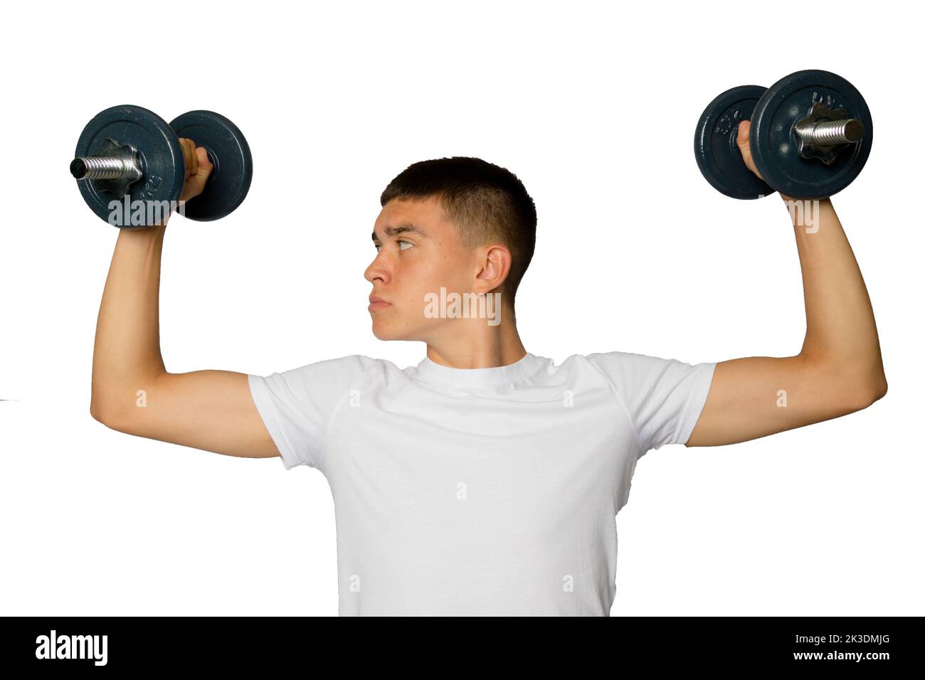 19 year old teenage boy lifting dumbbells Stock Photo