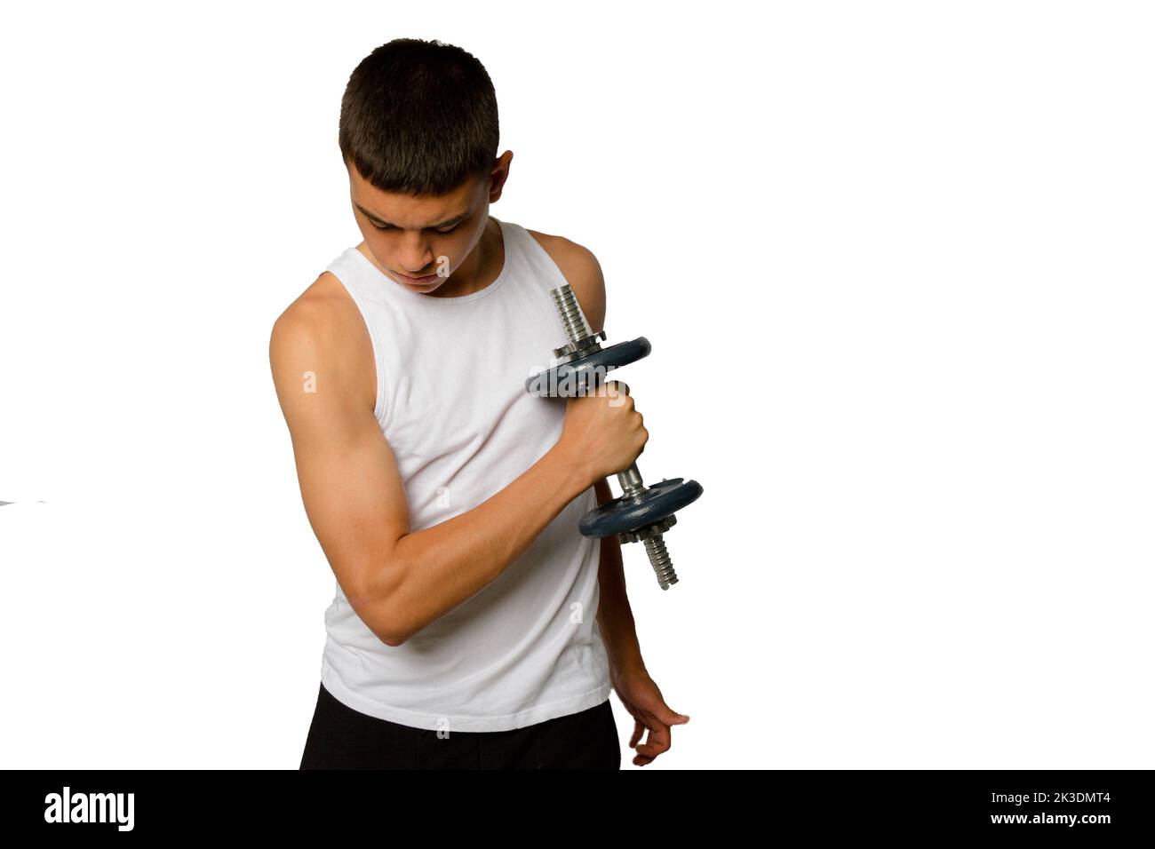 19 year old teenage boy in a tank top exercising his biceps Stock Photo