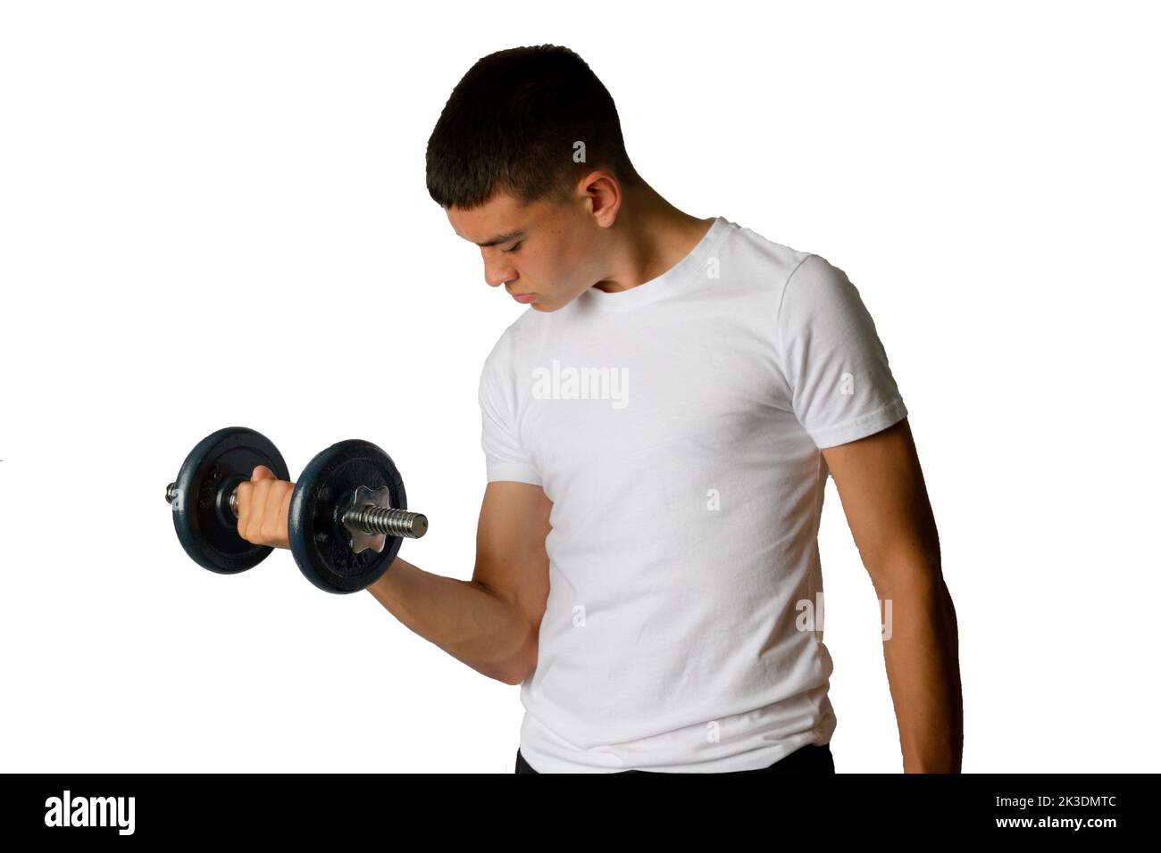 A 19 year old teenage boy lifting a dumbbell Stock Photo