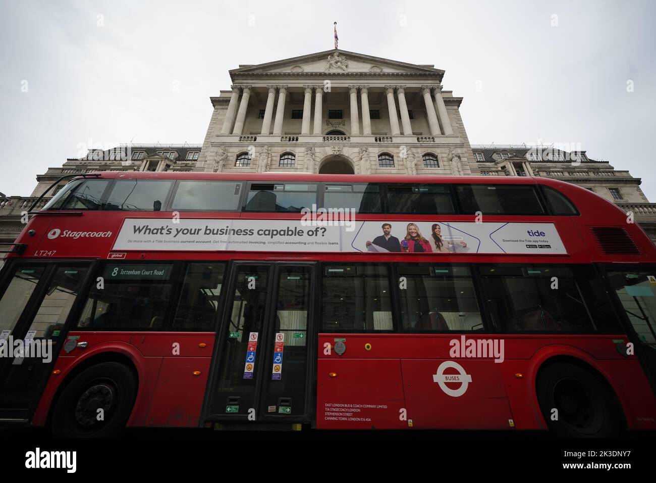A red London bus passes the Bank of England in the city of London after sterling hit its lowest level against the dollar since decimalisation in 1971. The pound fell by more than 4 percent to just 1.03 dollars in early Asia trading before rebounding to 1.09 dollars on Monday afternoon as speculation mounted over an intervention by the Bank of England, with officials there understood to be considering making an emergency statement this afternoon. Picture date: Monday September 26, 2022. Stock Photo