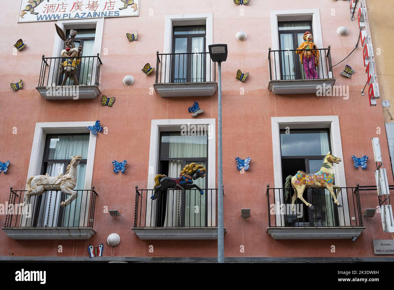 Spain, Figueras: facade of the Plaza Hotel with horses and characters in front of the windows, on balconies Stock Photo