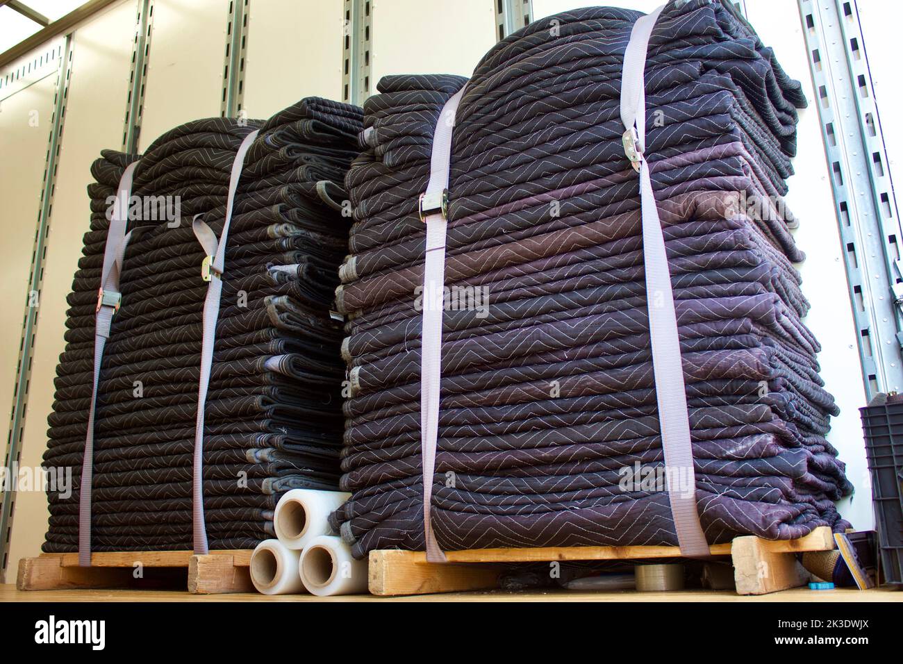 Empty moving and storage van with strapped moving blankets and plastic