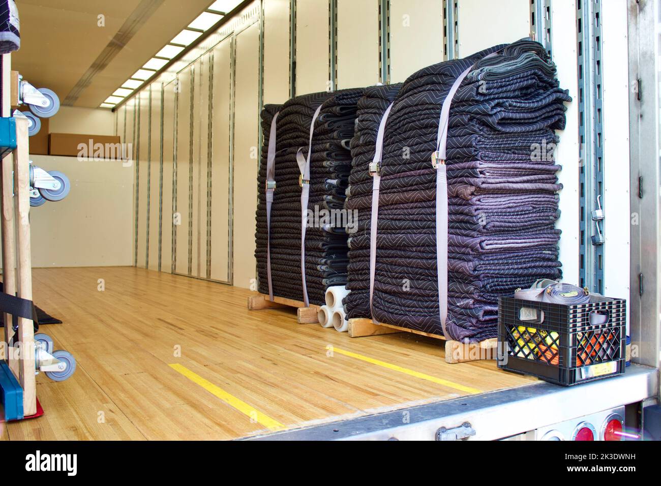 Empty moving and storage van with furniture dollies, strapped moving