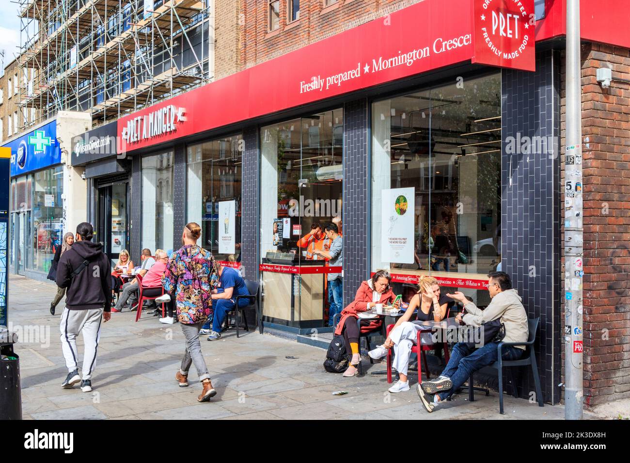 People seated outside Pret a Manger on Camden High Street, London, UK Stock Photo