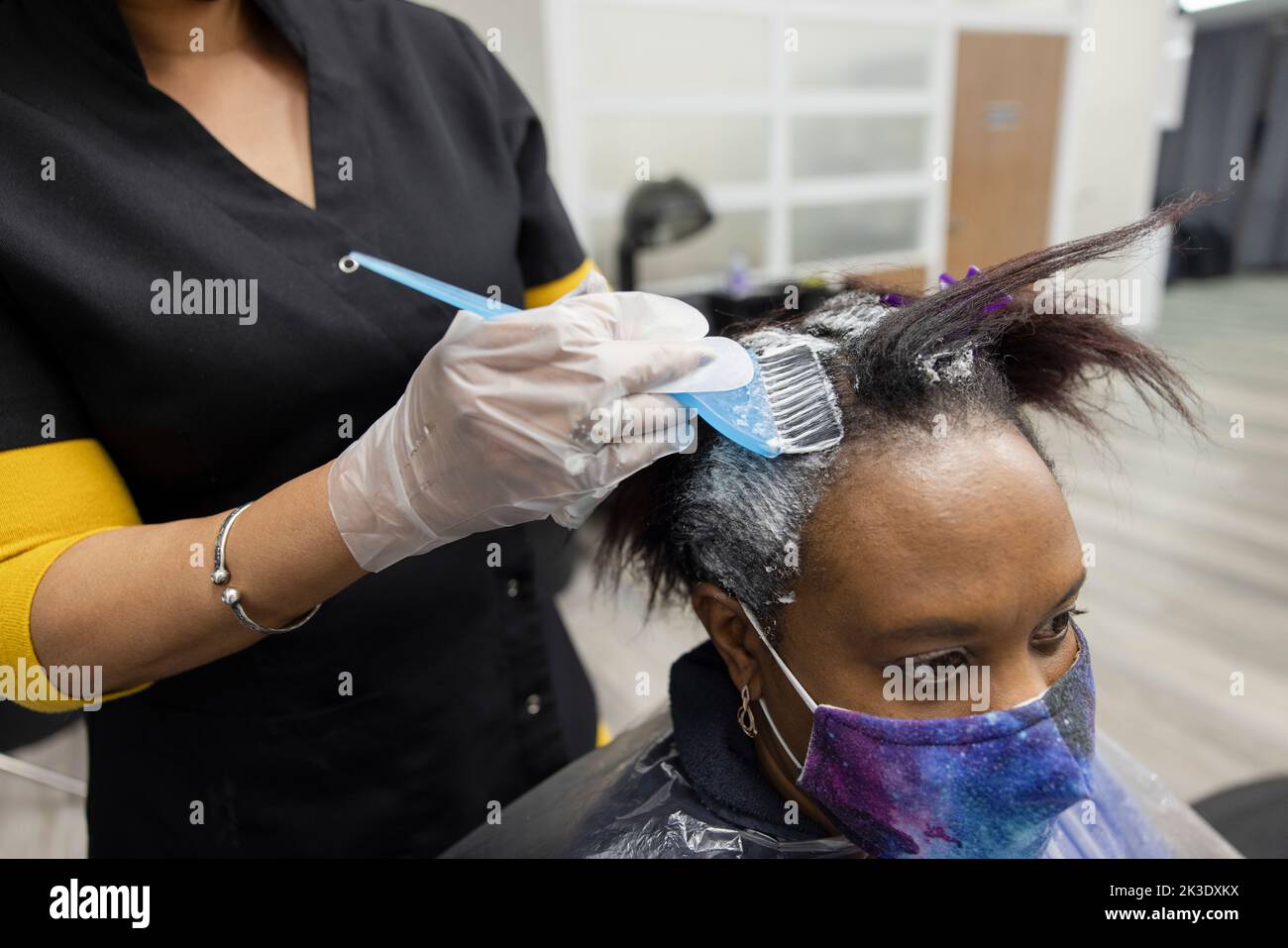 Close up woman getting hair highlighted in hair salon Stock Photo Alamy