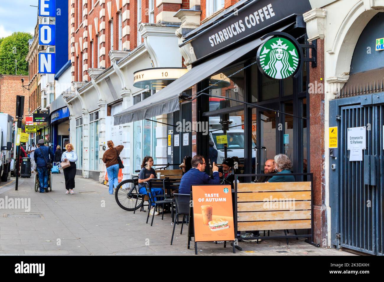 People seated outside Starbucks Coffee shop in Parkway, Camden Town, London, UK Stock Photo