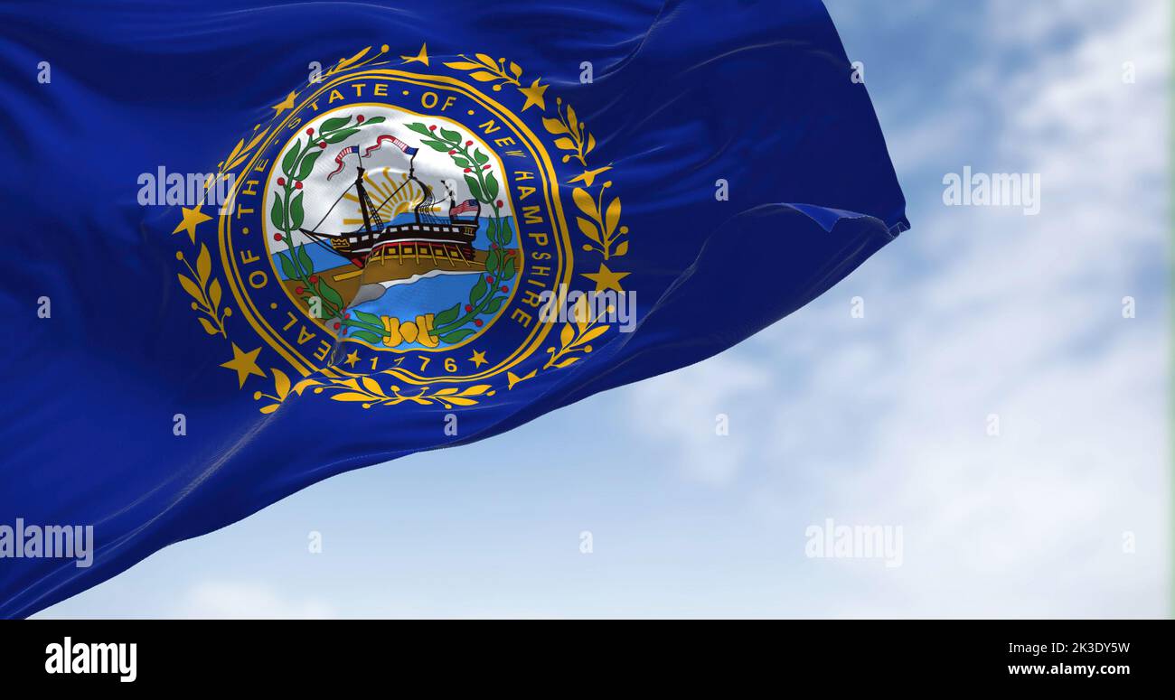The flag of New Hampshire state flag waving in the wind. New Hampshire is a state in the New England region of the northeastern United States. Us stat Stock Photo