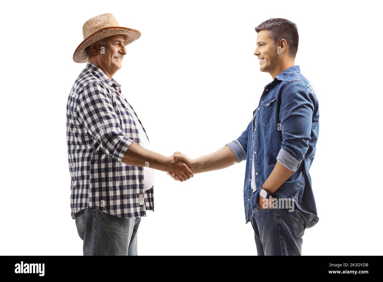 Mature farmer shaking hands with a young casual man isolated on white background Stock Photo