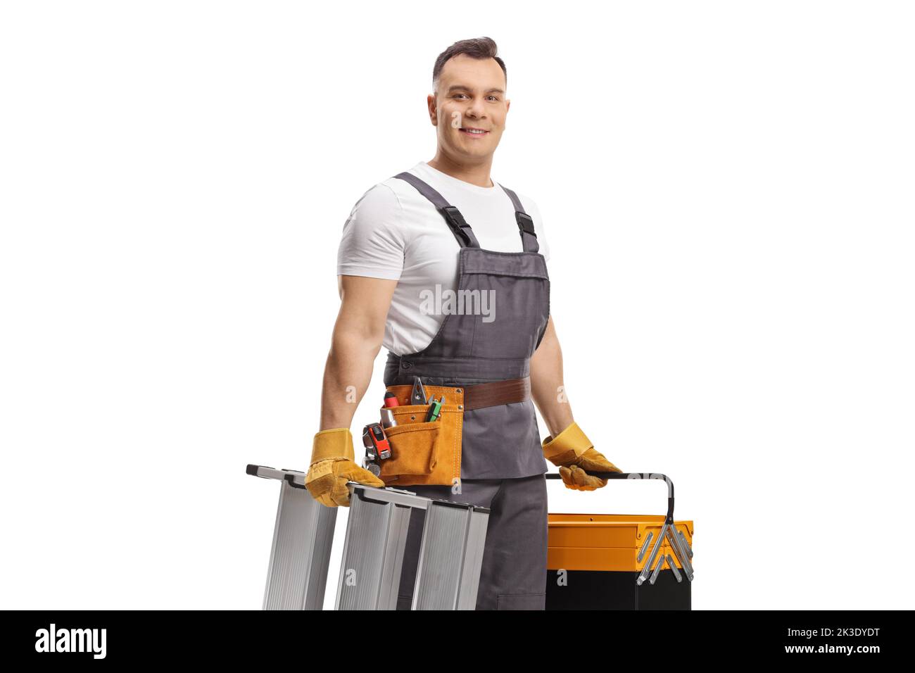 Repairman in a uniform carrying a ladder and a tool box isolated on white background Stock Photo