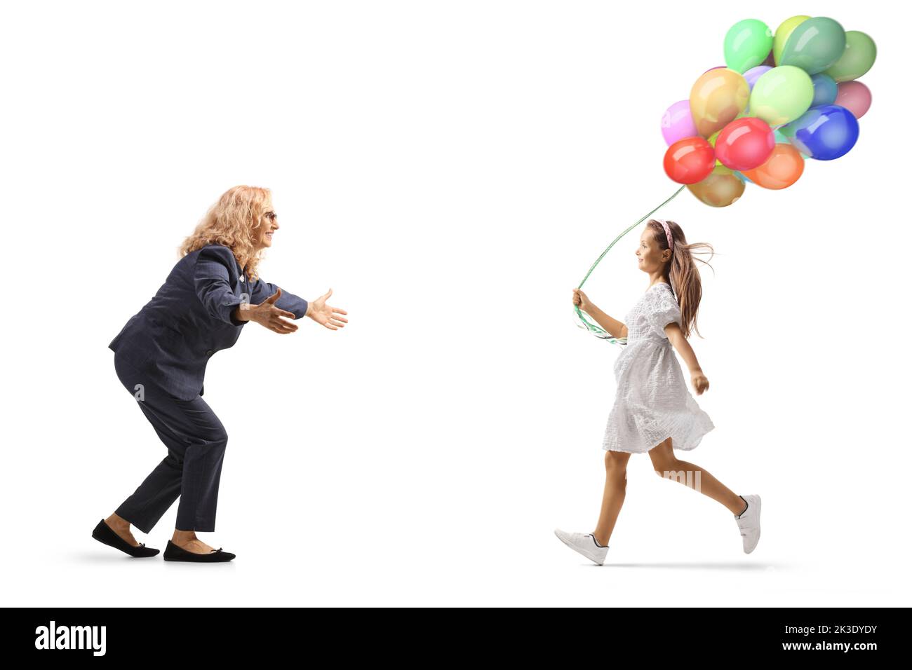 Mother waiting to hug her daughter running with balloons isolated on white background Stock Photo