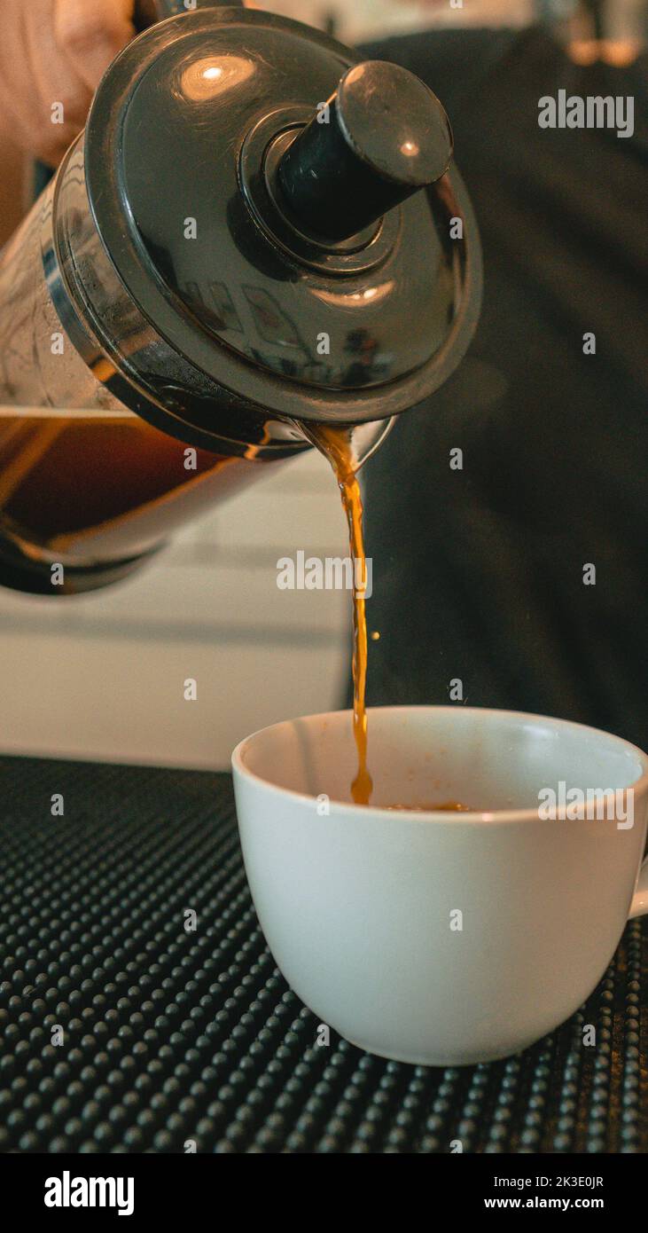 Pouring freshly brewed coffee from a French press Stock Photo Alamy