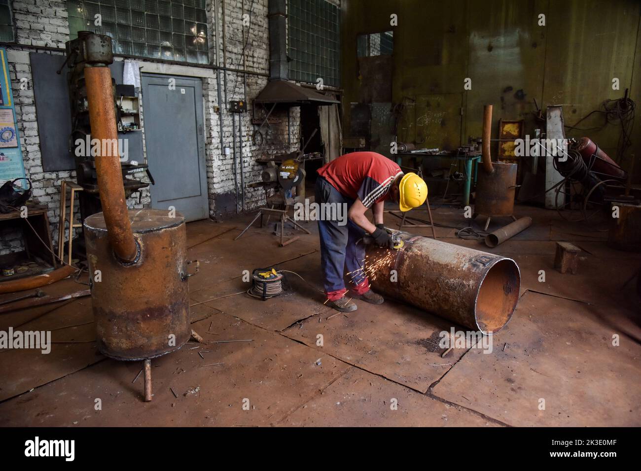 A worker of the Lviv utility company makes a blank for a special metal