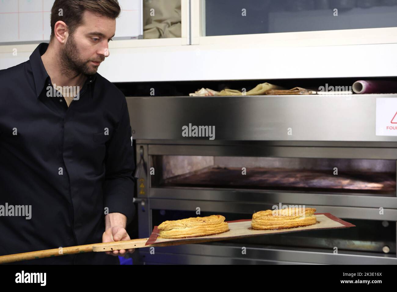 La Turbie, January 5, 2022: pastry chef making a “galette des rois” frangipane: baking Stock Photo