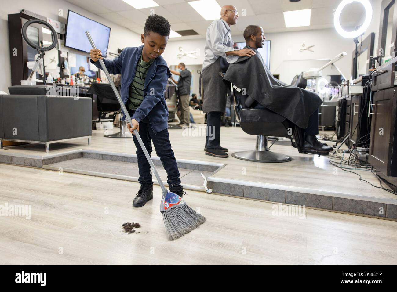 Boy sweeping floor hires stock photography and images Alamy