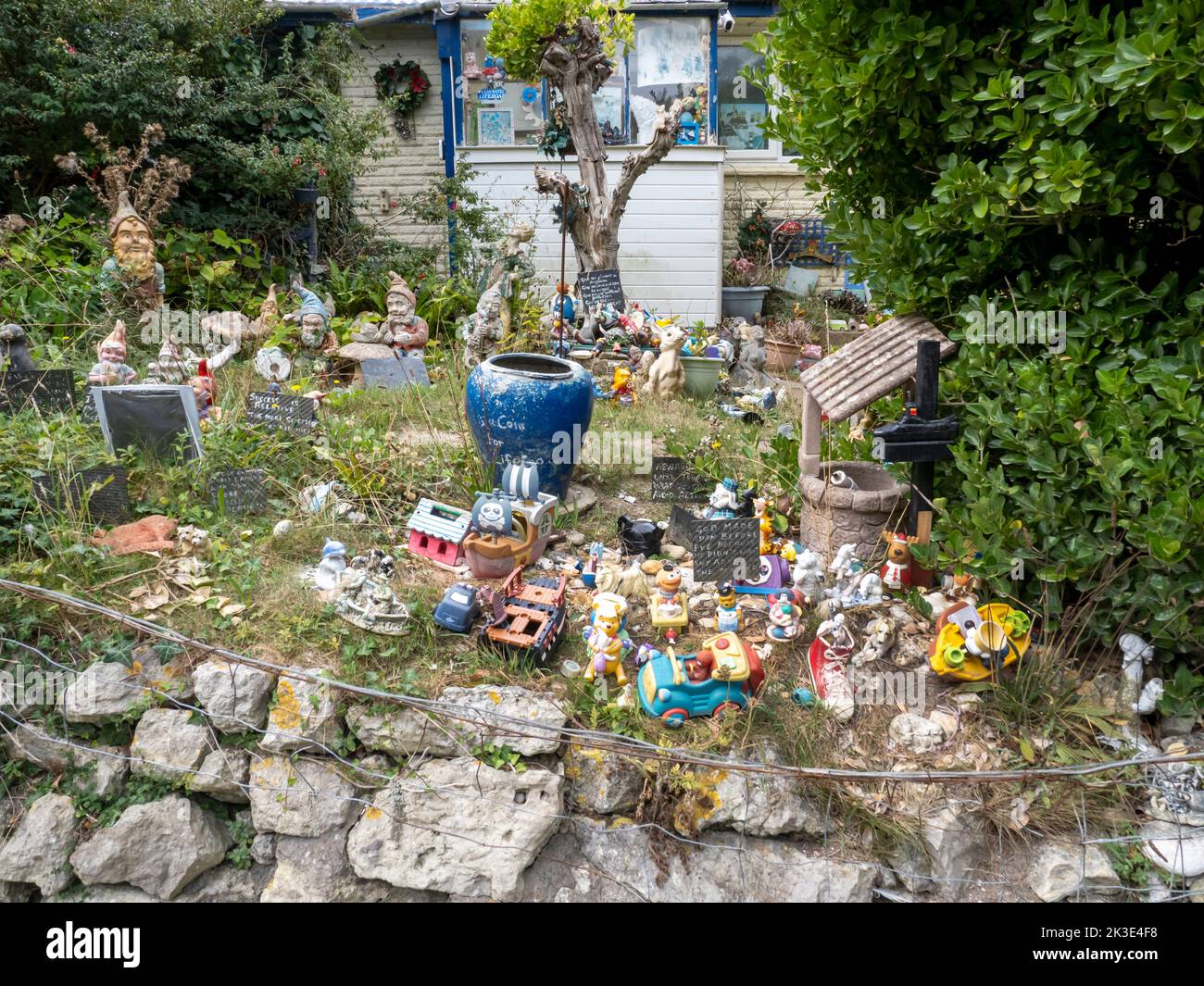 A garden with gnomes and other cheap tat on the west tip of the Isle of White, UK. Stock Photo
