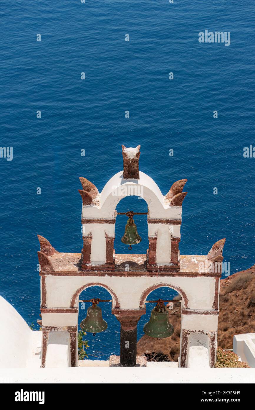 A typical white washed stone bell tower on Santorini. Stock Photo