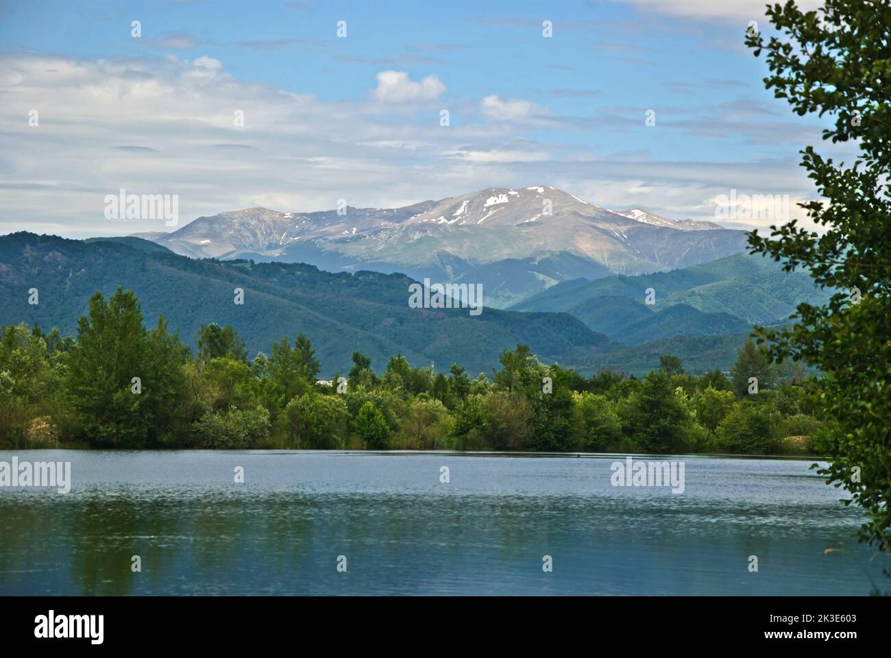 Summer landscape with lake, mountains, blue sky and clouds, in Gorj county, Romania Stock Photo