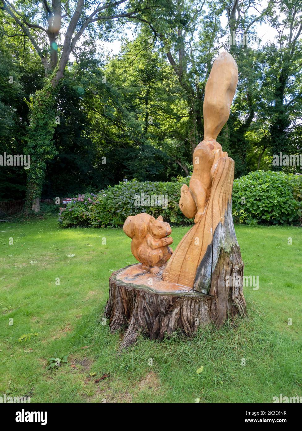 Red Squirrels carved into a tree trunk in Shanklin on the Isle of White, UK. Stock Photo