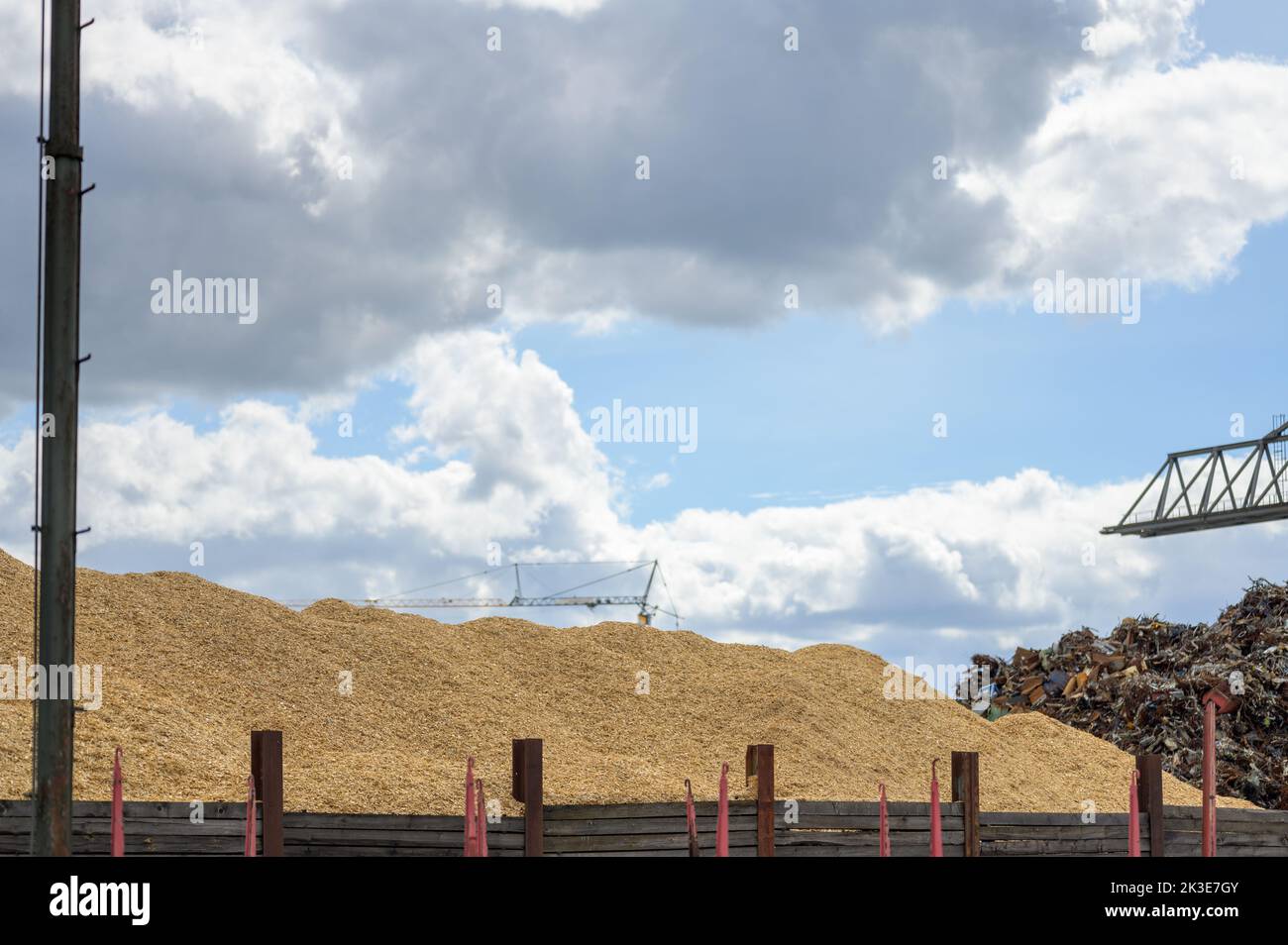 Huge mountain of sawdust and black coal in a concept of energy crisis