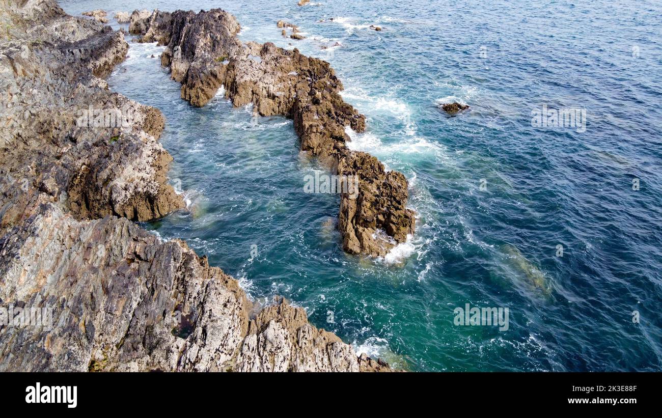 Beautiful sea waves break on the coastal rocks. White foam on turquoise ...