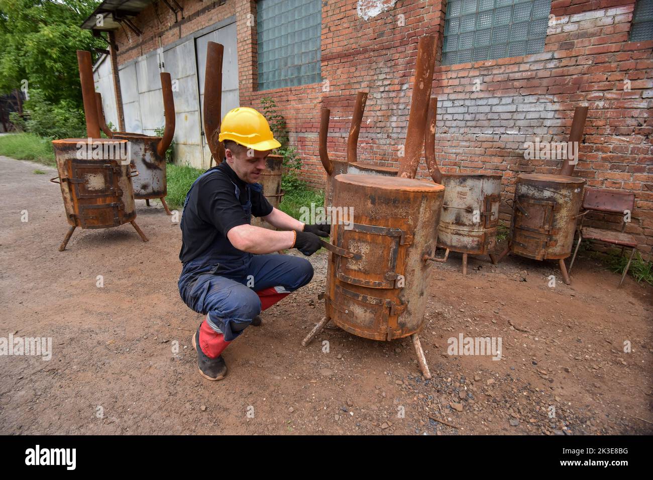 A man looks at a readymade special metal stove for heating the